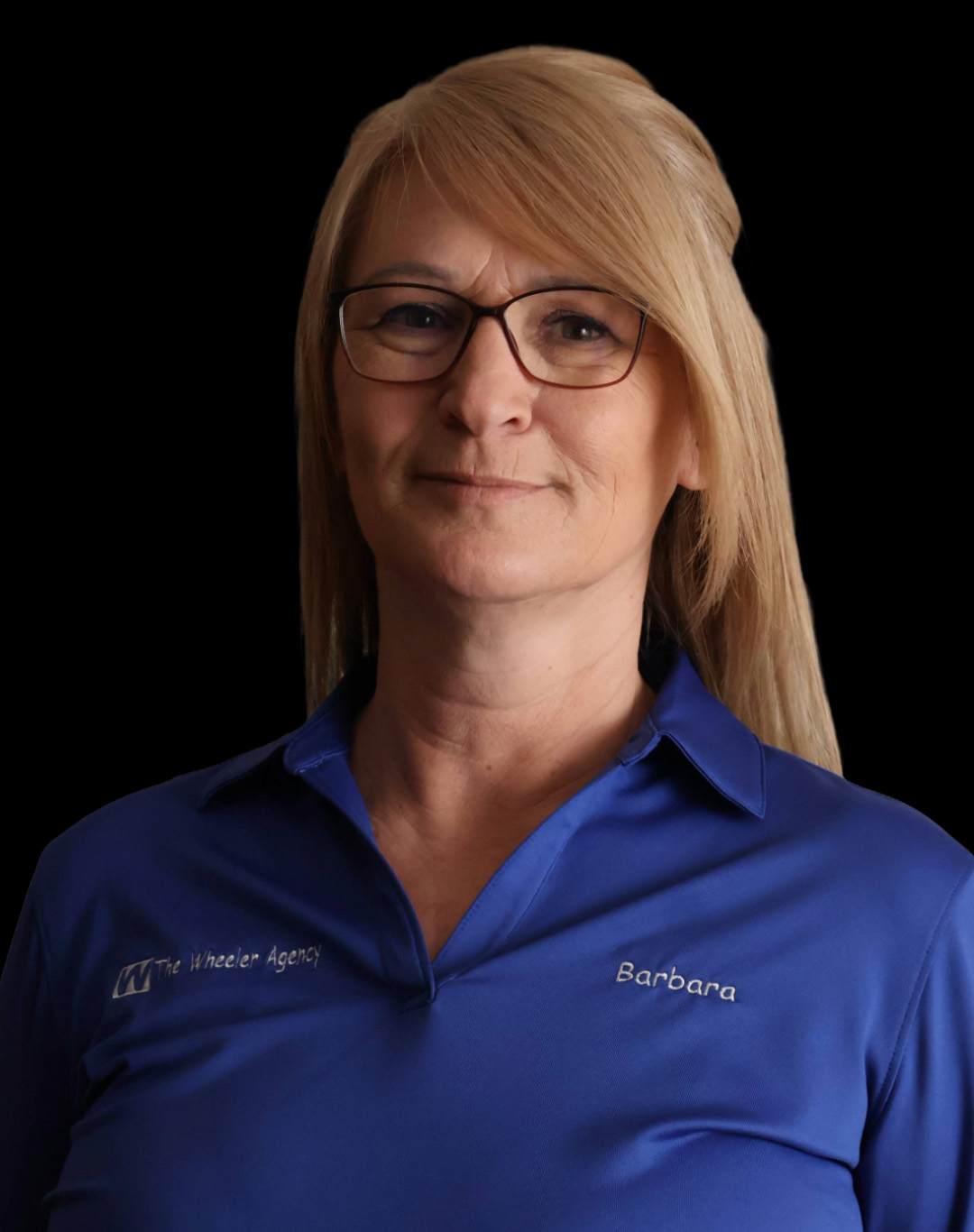 A woman with blonde hair wearing glasses and a blue shirt, looking confidently at the camera against a dark background.